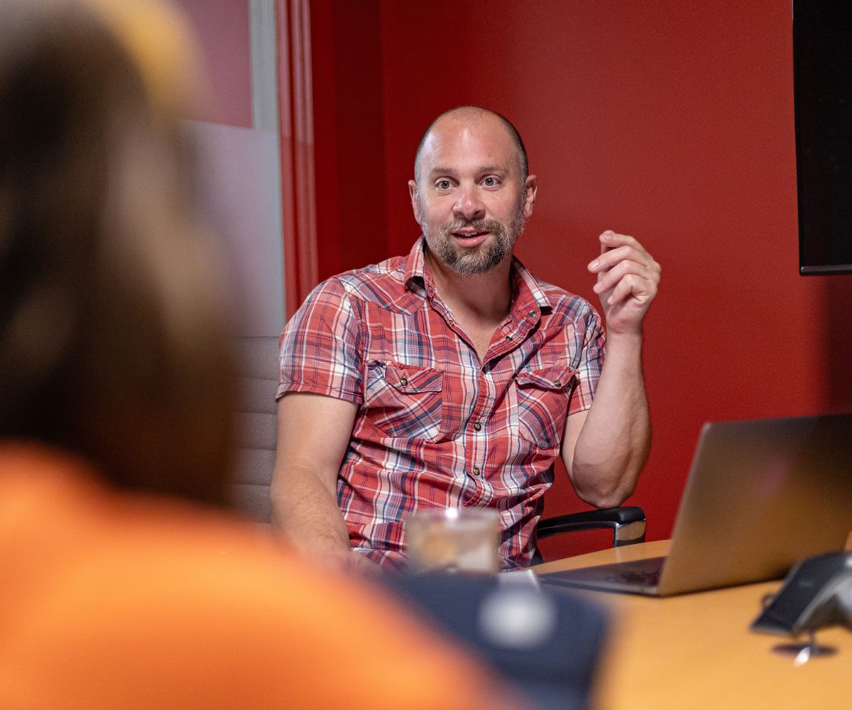 Orbiteer, Brian, focused in a meeting