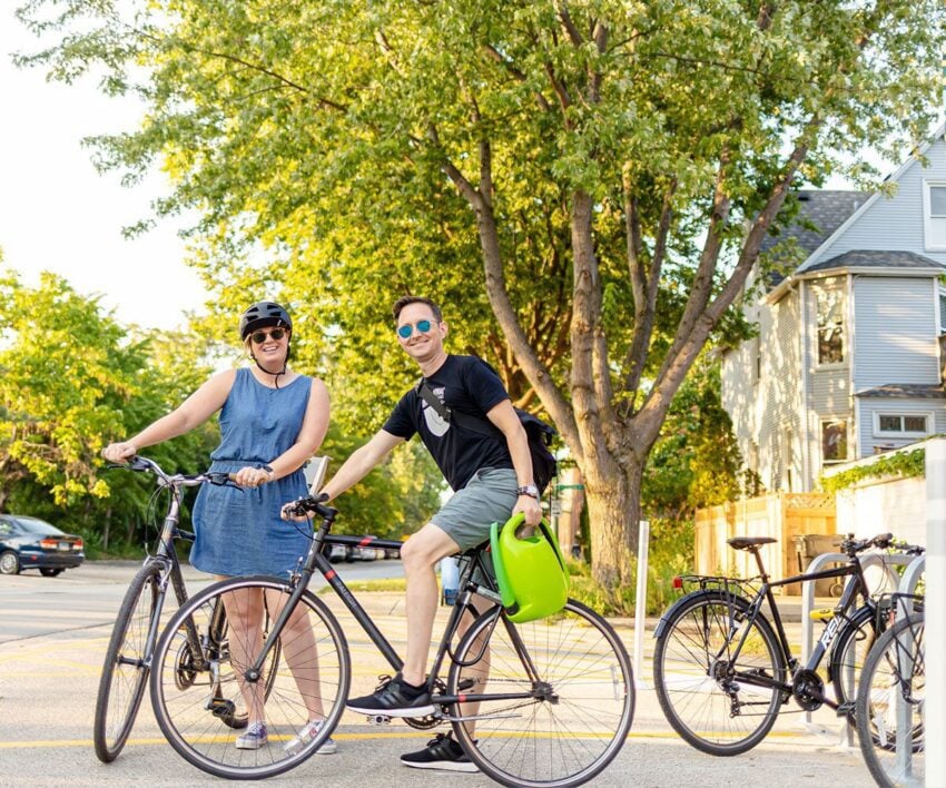 Orbiteers, Krista and Andy, on bike outside the office