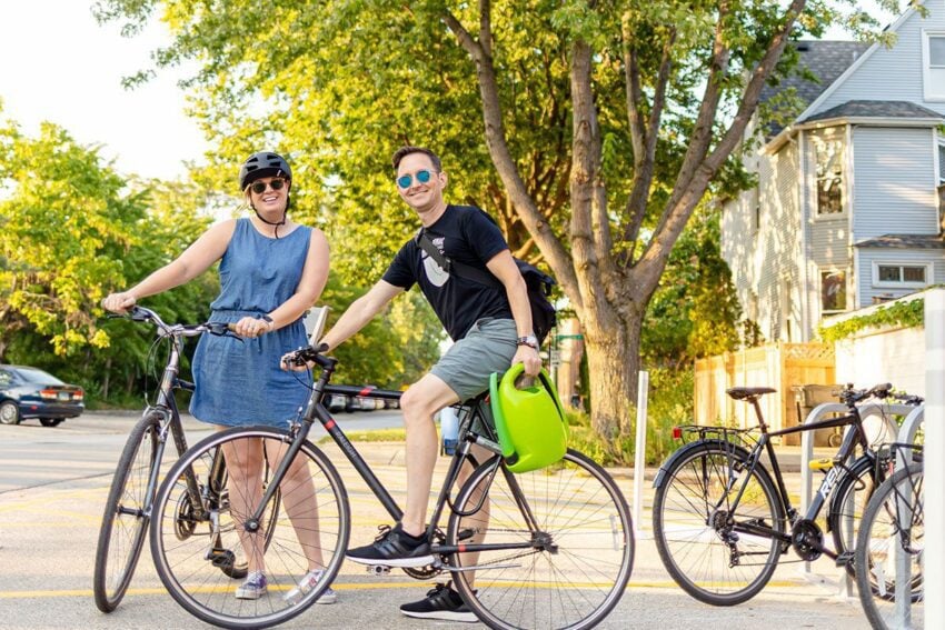 Orbiteers, Krista and Andy, on bike outside the office