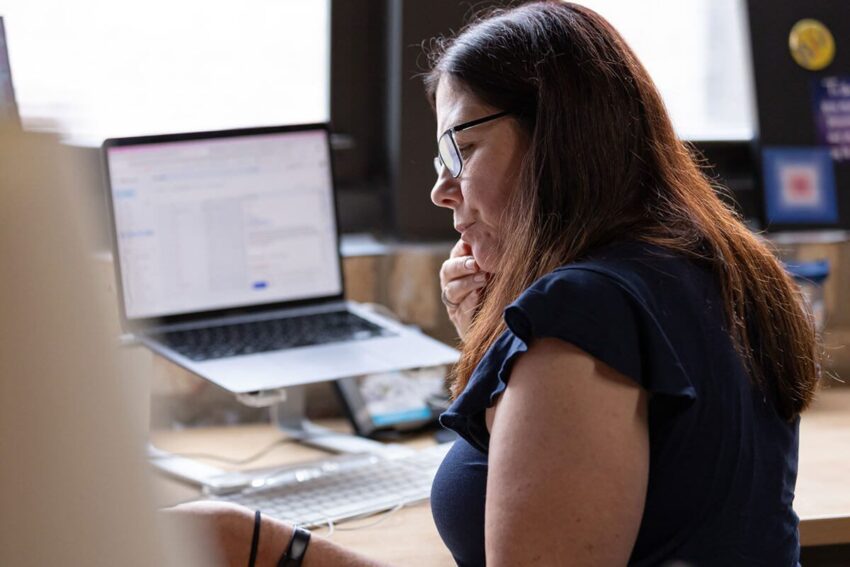 Stephanie thinking at her desk