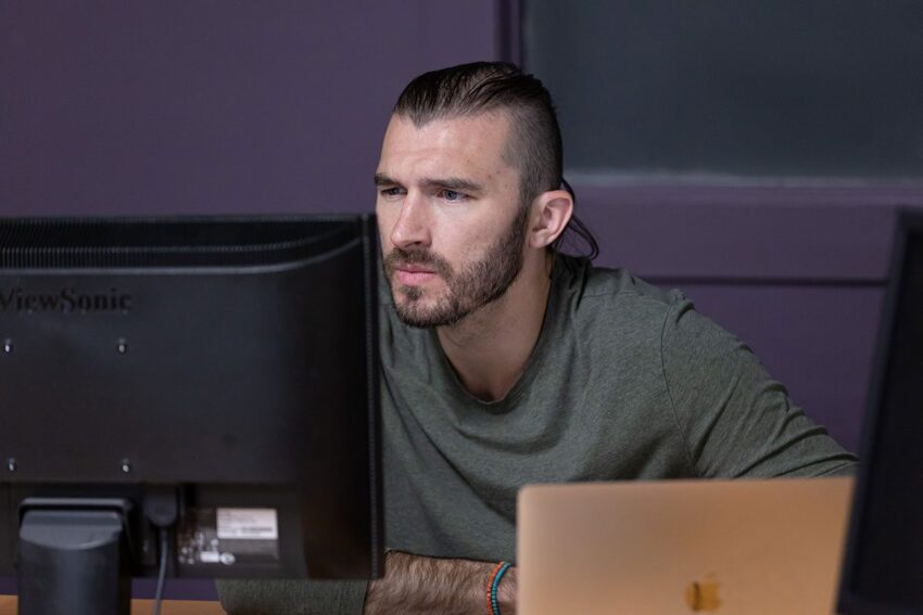 Tyler concentrating at his desk