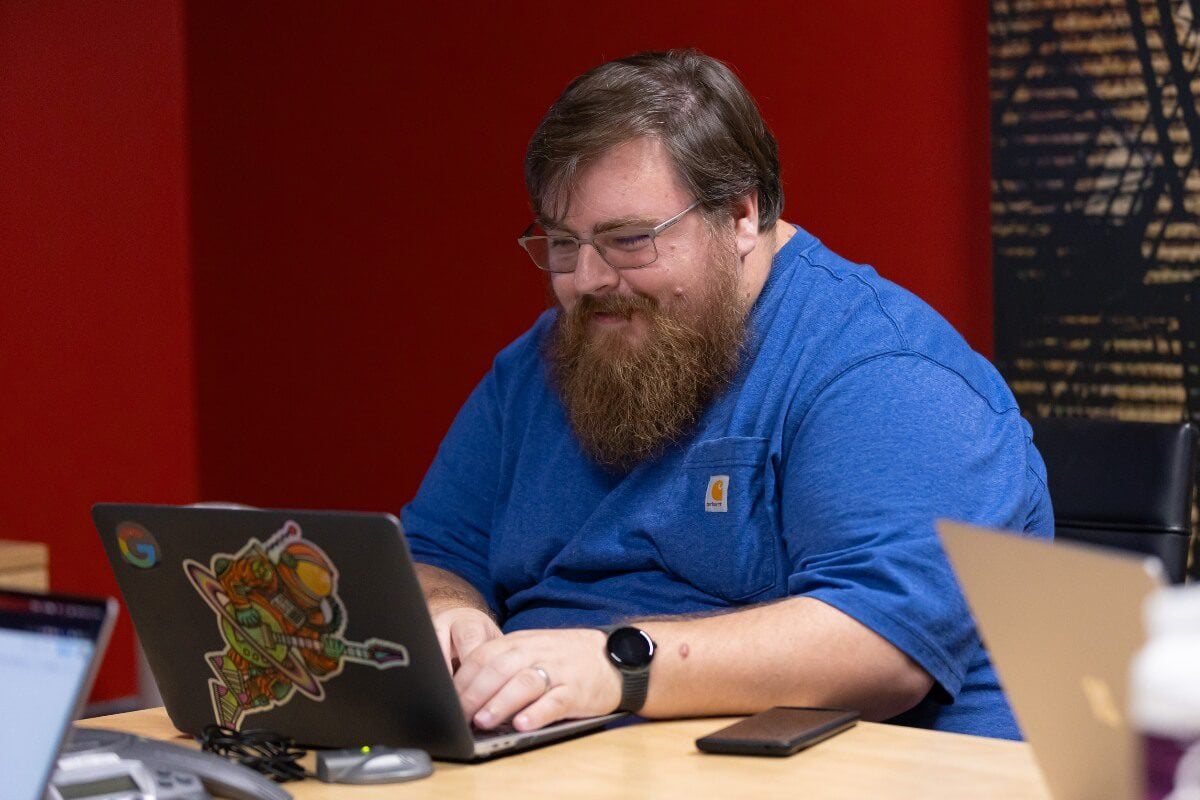 Optimization Analytics Engineer working at a computer