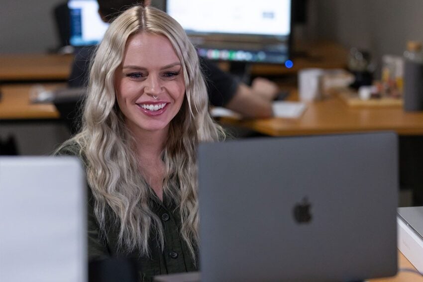 Jen working on her computer at her desk