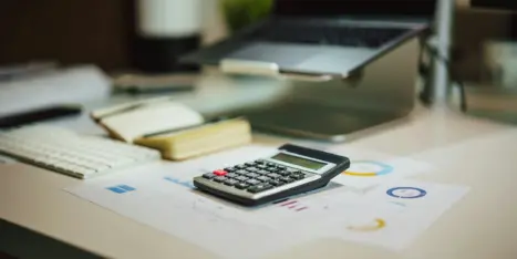 A desk setup featuring a calculator