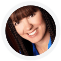 A woman with long brown hair and bangs, smiling, wearing a blue collared shirt, photographed inside a circular frame.