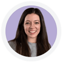 A woman with long dark hair and a gray top smiles at the camera, set against a light purple background framed by a white circular border.