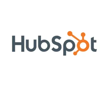 The HubSpot logo featuring the word "HubSpot" in gray text with the "o" stylized as an orange hub-and-spoke design on a white background.